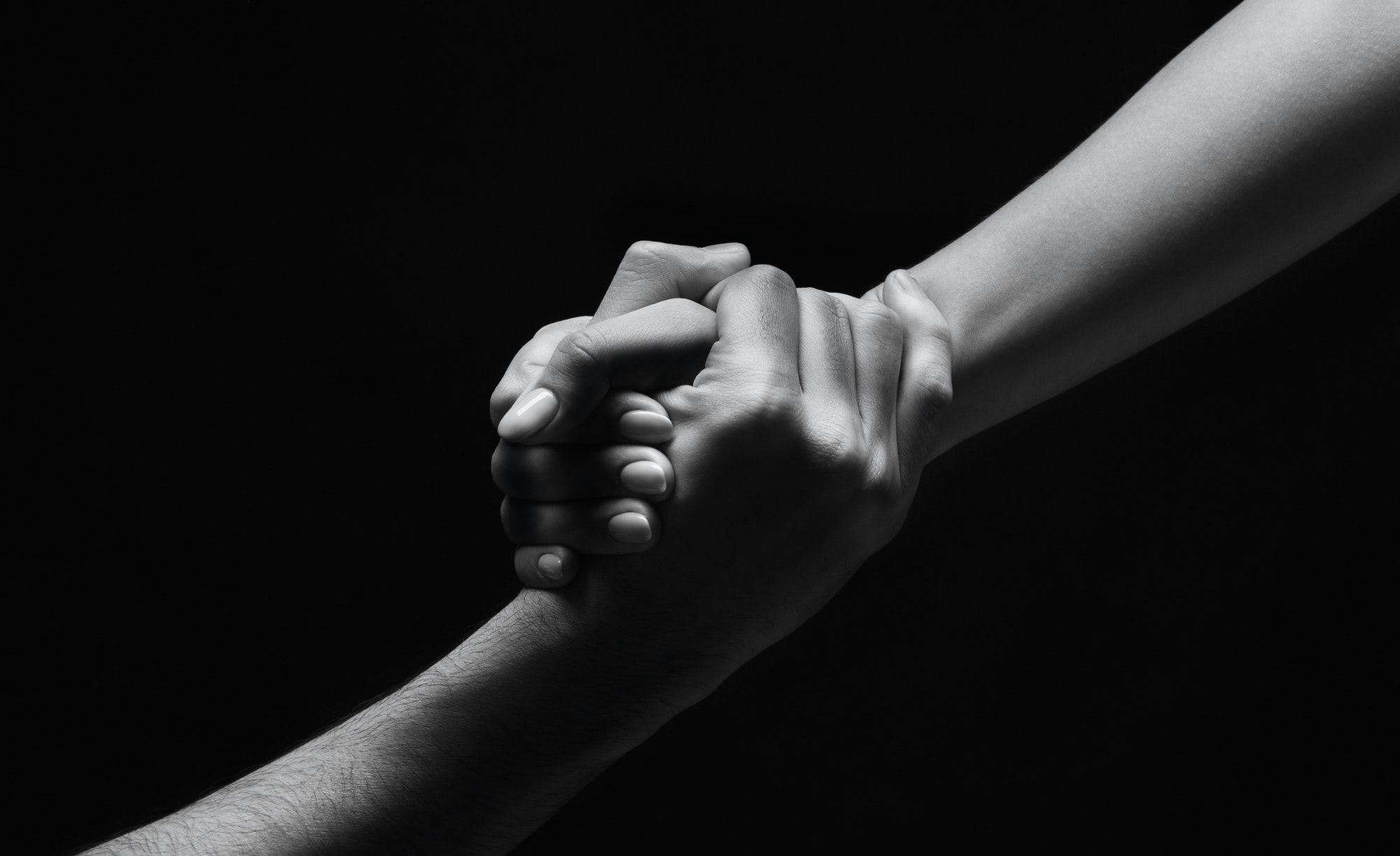 Unrecognizable woman hand helping man to stand up