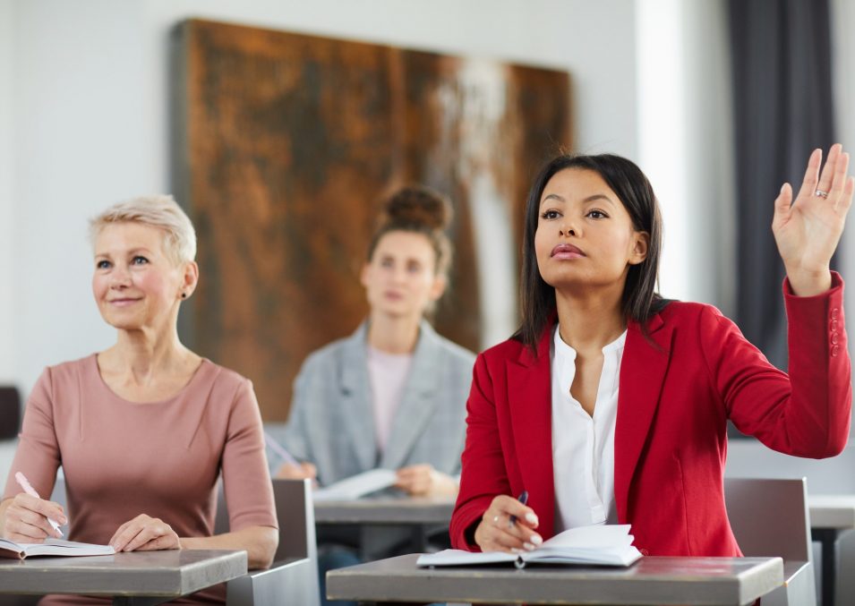 Businesswoman Raising Hand in Class