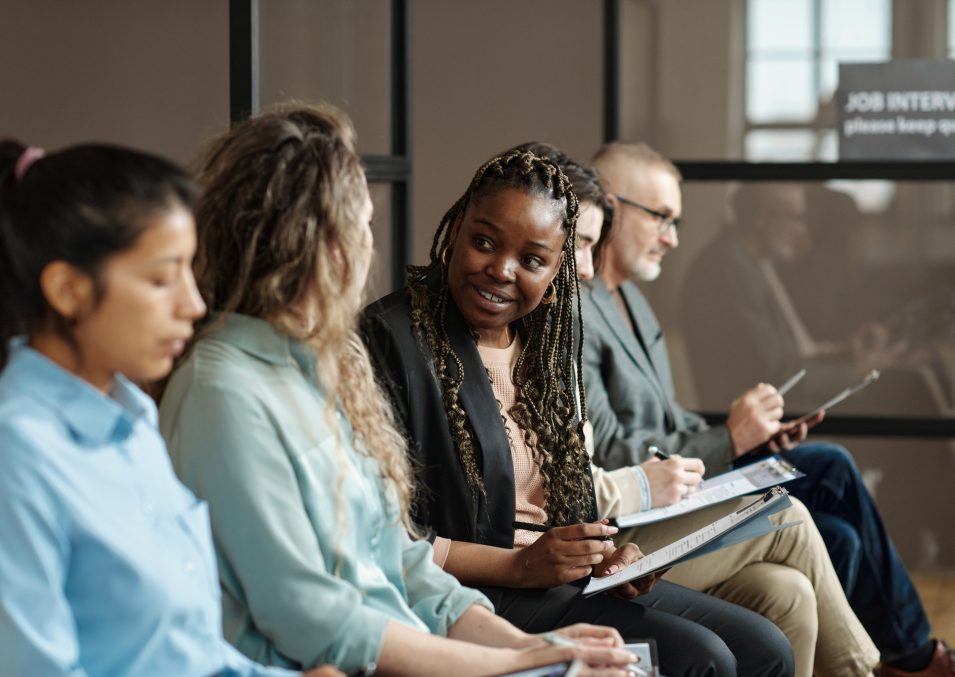 Group of candidates sitting in queue for job interview